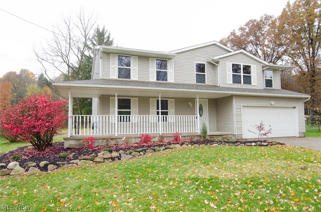 Four bedroom home in Tallmadge! Tucked back from the road on over an acre, with lots of privacy. The spacious floorplan begins with nice hardwood foyer & opens up to what could be used as a formal dining room, sitting room or play space for the kids. There is a bright living room that opens to the dining area & kitchen. This open space is perfect for entertaining & has sliders off the eating area, out to the large deck. The kitchen features new lighting, sink, faucet, stainless microwave, dishwasher, range, refrigerator & locking vinyl flooring. Off the kitchen is the main floor laundry room, with a large closet & access to the garage. There is also a half bath & coat closet on the first floor. Upstairs you can over look the bright 2 story entry & contemporary light fixture, from the second level. You will be ready to sign the offer, when you walk into the massive master bedroom! The master bath is wonderful as well, with new tile flooring, new tub & tile surround, new toilet