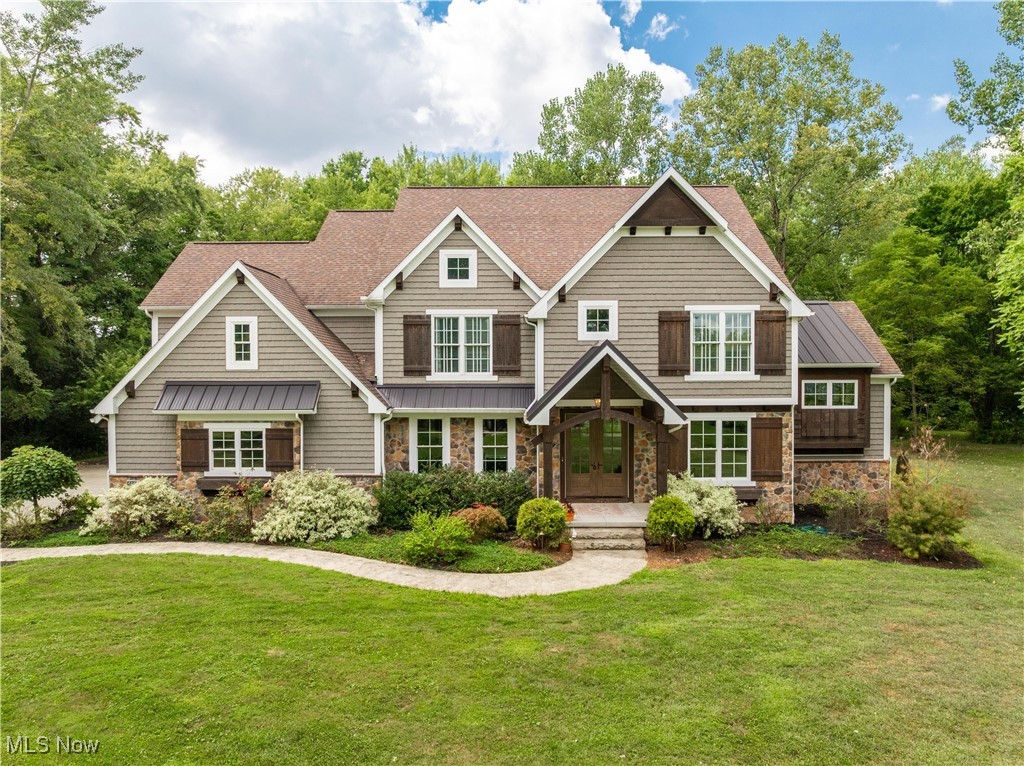 Welcome to this stunning custom-built Rembrandt home, perfectly situated on 5 private acres in the heart of Jackson Township. Built in 2018, this property combines luxury, functionality, and unmatched outdoor living. Step inside to an expansive foyer that opens to a front office and flows into the open-concept main level, filled with natural light. The great room features a cozy fireplace and seamlessly connects to the chef’s kitchen, complete with a walk-in pantry, spacious eat-in area, and a bi-fold door that fully opens for indoor and outdoor living. A sun-filled morning room is the perfect spot to enjoy your coffee, while the first-floor laundry and half bath add convenience. Upstairs, you’ll find four spacious bedrooms, including a luxurious primary suite, plus a versatile game room. The finished lower level offers even more living space with a media room, wet bar, full bath, and a potential fifth bedroom—ideal for guests. The property grounds are truly an entertainer’s dream. Enjoy an outdoor grilling area with a fire table, a stamped concrete patio, a bocce court, a separate fire pit area, and trails that wind throughout the wooded acreage. A 34x40 heated outbuilding provides parking for up to six additional cars and endless opportunities for hobbies, toys, or a workshop. This home is the perfect blend of sophistication and comfort, inside and out.