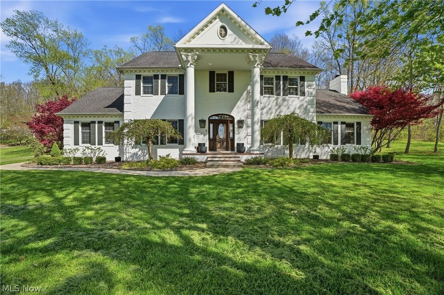 Situated on 2.89 acres of notably flat, mature-tree-lined grounds, this property commands a grand approach and delivers a true estate setting from the moment you arrive.
Inside, over 3,500 square feet of perfection awaits…featuring nine-foot ceilings, Carrara marble tile at the entry, and crystal chandeliers in the foyer and dining room. The main level is anchored by a spacious primary suite complete with a walk-in closet and  primary bath showcasing custom cabinetry, updated fixtures, and a jetted clawfoot tub. Also on the main floor: an updated laundry room and a large, light-filled kitchen outfitted with luxury appliances, granite countertops and granite tile floors.
From the kitchen, flow seamlessly into the main living area, featuring a gas fireplace, bursts of natural light, and cathedral ceilings. Feeling playful? Check out the billiards room, which conveys with the home. The four-season sun porch may just become your favorite room in the house: equally suited to early mornings with coffee or quiet afternoons with a good book, with views that remind you why you chose this property in the first place.
Upstairs, three additional bedrooms, each with walk-in closets, two full bathrooms, and an office nook. The lower level offers generous storage and strong potential to be finished as a home gym, media room, or additional living space. A three-car garage and ample additional parking round out this exceptional offering.
Directly accessible to the Rails to Trails path for biking and walking through beautiful scenery, and ideally located close to excellent schools, medical facilities, and restaurants…this home lives privately while keeping everything within easy reach.