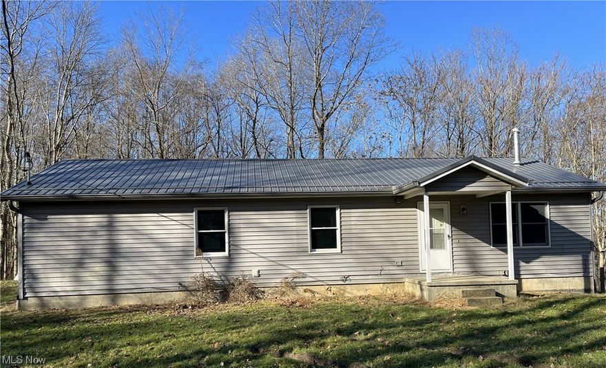 Just what you've been looking for a 3 bedroom ranch in a private wooded setting on nearly 6 acres.  This secluded home is within minutes of New Philadelphia and Tall Timbers private lake.  This home features a large detached garage, deck off the back, metal roof, wooded lot with privacy and nature, first floor laundry, and large master bath.  You won't want to miss this country home.