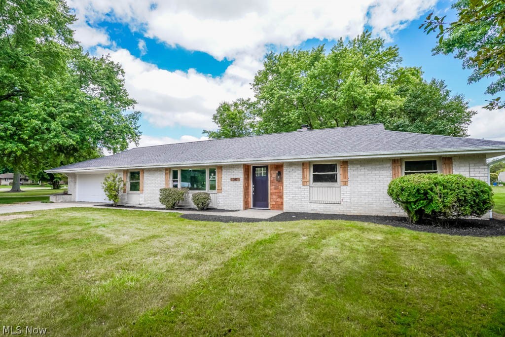Beautiful all-brick ranch on over half an acre in Plain! Remodeled inside and out with a new roof, gutters, garage door, exterior doors, electric panel, flooring, paint, lighting, and more. Cedar shakes accent the entry, leading to a newly designed open concept. Vinyl plank flooring connects the living room to the dining area, featuring a fireplace and a brand new kitchen with granite counters, stainless steel appliances, white cabinetry, subway tile backsplash, and a center island with counter seating. The sliding door opens to a patio, perfect for al fresco dining with views of the treed backyard. Down the hall are three bedrooms and two remodeled full baths, including the master with a double closet and en suite bath with a tiled step-in shower. The finished rec room with new carpet and an open joist ceiling provides a cozy spot to gather with friends and family. With over 2000 square feet of living space and a wonderful location, this home won't disappoint. Call to see it today!