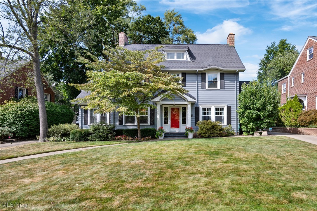 The brick paved streets and classic lamp posts of Historic Ridgewood set the perfect tone for this lovely home, loaded with warmth and charm! Enter through the front door with leaded glass sidelights into the inviting entry foyer. You'll immediately feel the comforts of home from original gleaming woodwork to the beautiful open staircase. Through french doors, you'll find the living room, showcasing a wood burning fireplace and wood floors. A decorative door leads to the delightful screened porch, the perfect place to relax and unwind. The dining room sets the stage for the perfect place to entertain, complete with wainscoting and a chandelier. The bright and airy sunroom provides yet another wood burning fireplace. The updated eat in kitchen is a cooks delight, with updated cabinets, quartz countertops, a breakfast bar, beadboard accent wall, awesome appliances, plus a wine rack and bonus desk area for meal planning. The eat in area showcases a beautiful view of the rear yard where you'll find the low maintenance composite deck with a tranquil water feature, leading to the park like yard and 2 car detached garage with added storage above. Just off the kitchen is a convenient half bath and closet. Upstairs to the second floor, where you'll find 4 bedrooms all with hardwood flooring plus a large full bath. Open the door and head up to the third floor where you'll be delighted to discover the owner's oasis, complete with the primary bedroom, large sitting area and a full bath. Replacement windows, Gas boiler 2023, 22 amp electric service, hot water tank in 2017, Simply Safe Security and cameras, newer concrete drive, new garage doors and openers. The perfect blend of historic beauty and modern conveniences.