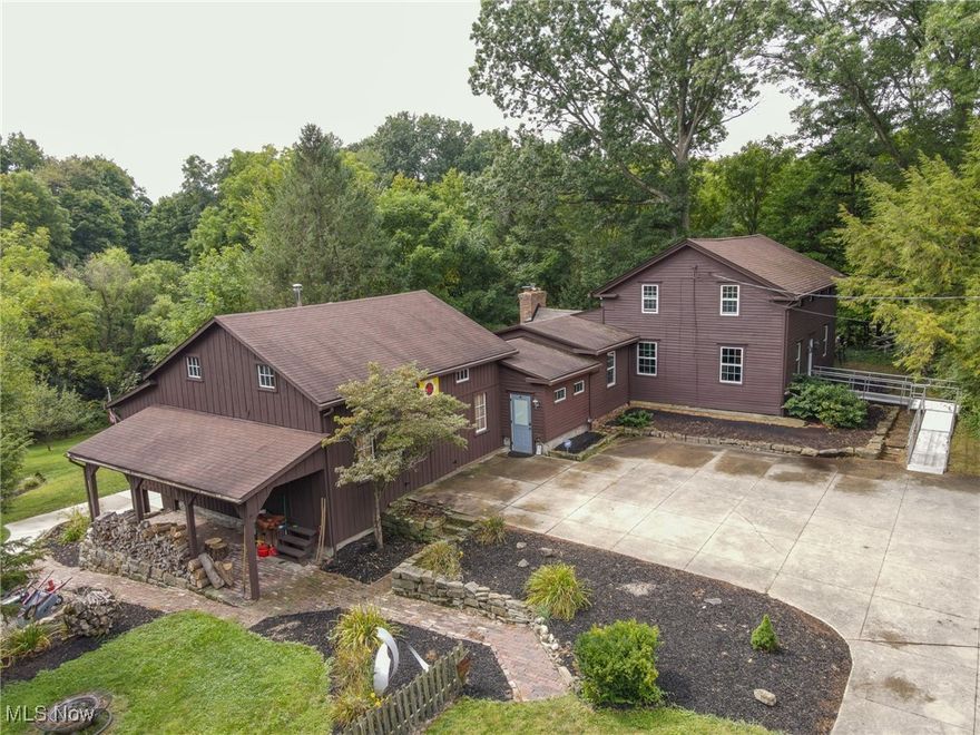 Charming Georgian Colonial Saltbox style home located in coveted the Canfield School District. This Century Home has been well cared for and retains all of the original charm from the wide plank hardwood floors to the period correct paint colors. The expansive first floor consists of the formal living room, dining room, family room with fireplace, the primary bedroom with full bath across the hall. Upstairs you will find 3 additional bedrooms that share a full bath. First floor laundry room, storage galore and a full basement with the potential to be finished and even has a walk out to the yard. The 20ftx40ft composite deck has hosted numerous parties and set on a park-like 1.27 acre lot with a creek. This home is a woodworkers/crafters dream come true! Wait until you see the attached shop, with attic storage, back storage area and wood burner so you can work on your projects year round. As if this one couldn't get any better it did! Below the workshop is a newly finished fully equipped efficiency apartment that has a separate entrance, perfect for your in-laws, your college student or whatever your family may need! The freshly painted exterior, new windows, plumbing updates, and electrical updates are just a few of the things that have been taken care of for you. Do not miss your chance at this stately beauty!