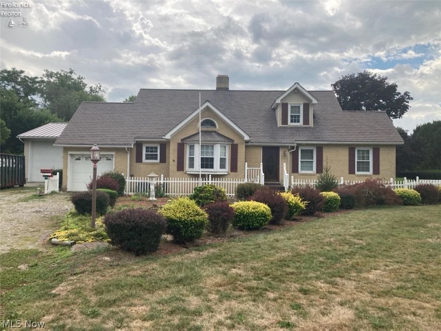 This Cape Cod-esque home exudes curb appeal from the mature landscaping and picket fence all the way to the cohesive colors chosen for the exterior. Situated on 2.31 beautiful acres of property, this home has just over 1,600 square feet of living space on three separate floors. Heading inside through the foyer there is a large living room flanked with arched doorways and beautiful crown moulding. The fireplace is the perfect spot to cozy up in front of. The beautiful woodwork flows throughout the entire home and showcased by built in bookshelves and storage areas. The kitchen is large and open with an abundance of light and there is also a formal dining room. The main floor also features two of the four bedrooms with the master on the main level. Upstairs are the additional two bedrooms. Heading back down to the basement, there is an additional family room with built ins and a fireplace as well. Back outside is a garage lover's dream- in addition to the one car attached garage, there i
