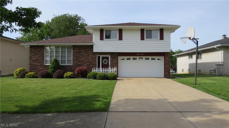 Move right in to this lovingly & well-maintained 3 bedroom, 1 1/2 bath split level with 2 car attached garage in a desired & convenient area in Parma! Enter into the spacious foyer with updated entry door and slate flooring. The kitchen features eat-in area with breakfast bar and updated wood laminate flooring. The cozy and spacious living room features crown molding, chair rail trim and beautiful front window. The crown molding and chair railing continues into the elegant dining room. Updated, neutral bathrooms including newer bath fitter (2013). Nice sized bedrooms, master has double closets. Partially finished basement great for entertaining! Beautifully landscaped yard with trex deck, covered patio & adorable shed. UPDATES galore! Including roof (2012), hot water tank (2011), furnace (2011), AC (2011), electrical (2015), dishwasher (2016) and a one month old washing machine! Other important improvements include glass block windows, driveway, sliding door, windows, trex deck and gar
