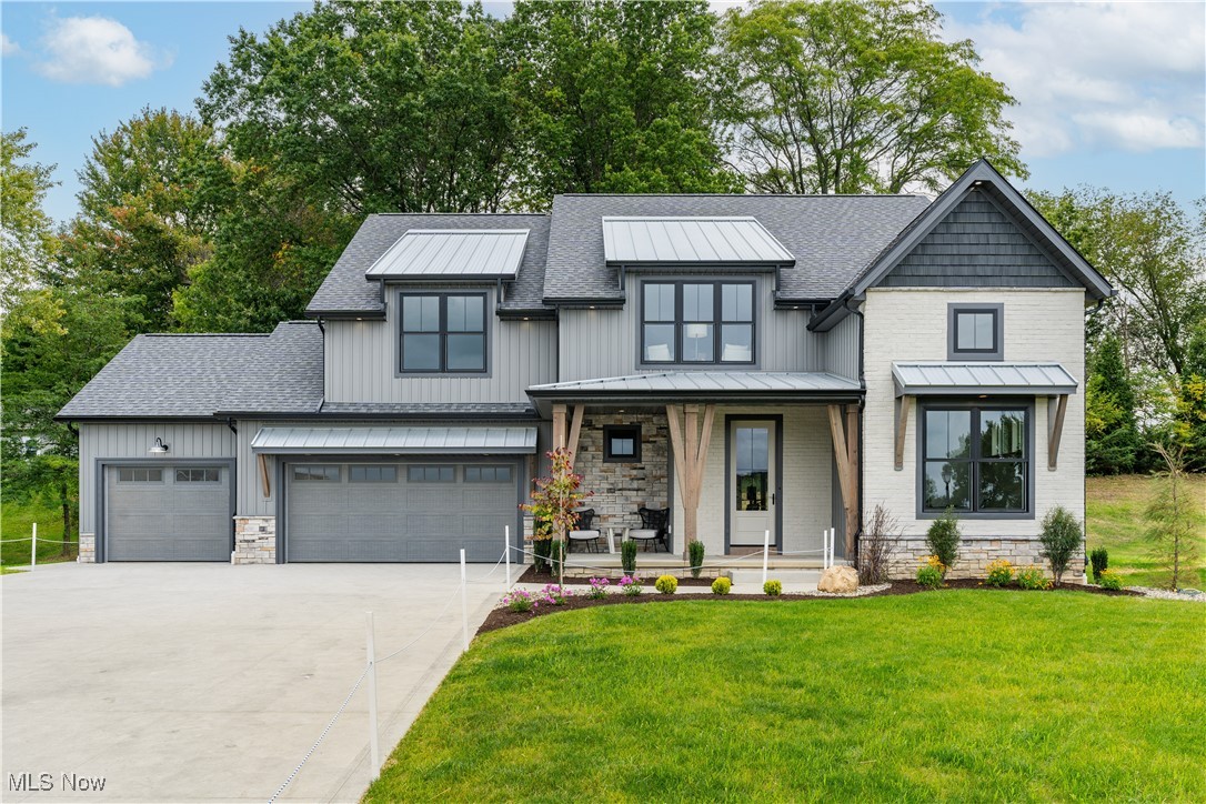 Discover this new Vega home with premium amenities in The Woodlands neighborhood in Hartville, Ohio. Enter through the covered front porch, using the 8-foot front door and into the inviting, open foyer. The designer, Amish-built kitchen boasts an oversized quartz island and walk-in pantry. The custom wood finishes extend throughout the main level, including the foyer, fireplace built-ins, kitchen island and mud drop area. Enjoy natural light pouring in on the South side of the home, including the first-floor study with cathedral ceiling next to the posh powder bath. Follow the custom metal railing on the staircase to the second-floor, where the serene primary suite is finished with a custom tile shower, double vanity and spacious walk-in closet. Across the open entertainment space, you'll see the laundry room, ample closet storage, and additional two bedrooms which share a bathroom. Schedule your private showing to view this 2023 Stark County Parade of Homes "People's Choice Award" winning home today.