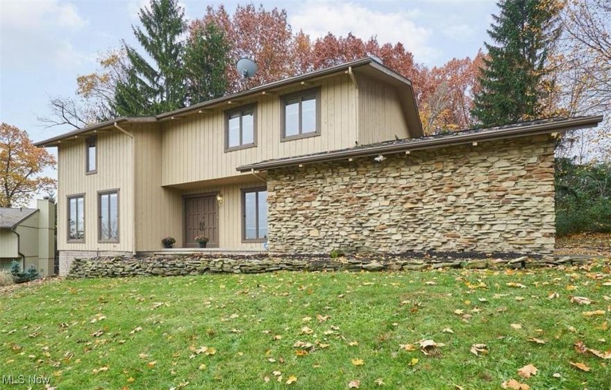 Nature lovers will love this beautiful Merriman Woods home! This five bedrooms, 4.5 bath home is minutes from the parks and restaurants in the Valley and Highland Square. The first floor offers a wonderful area to entertain, with an open floor plan between the eat-in kitchen and family room. The family room has a slider to a spacious deck. The large living room has huge windows that allow for beautiful metro park views. The main living area also includes a home office and dedicated laundry area.  The attached 2-car garage gives provides of access to the main living space.  The second-floor master suite has 2 walk-in closets, an en-suite bathroom, a wood burning fireplace, and a new private balcony/deck. There are three additional bedrooms on the second floor and two more full bathrooms. The lower level (basement living area) has been finished with another full bathroom, an office/kids art room, and a large recreation room, complete with a bar for entertaining. The seller made a lot of important updates after purchasing the home in 2019: New roof 2019, Gutters and downspouts 2020, Outside spot lights 2021, Parking lot driveway 2020, Landscaping. River rocks (80 Ton) and plants 2021, Kids play area 2020, Shed 2021, Back deck and patio 2021, Water heater (75 gallon) 2019, Radon system 2019, New garage door 2021, Garage epoxy floor 2021, Garage heater 2021, New appliances, New electric panel, Furnace/AC booster fans for upstairs. Prior to this seller's ownership, the basement had been waterproofed by Ohio State Waterproofing.  In addition to all the great updates, you will love waking up everyday to all of the wonderful views the Cuyahoga Valley National Park!