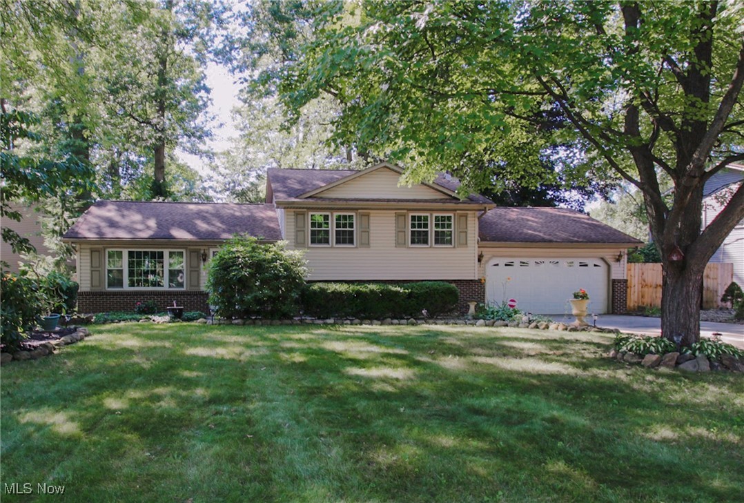 Welcome to this beautifully updated 3-bedroom, 1.5-bath split-level home located in the desirable Highland Park neighborhood of Austintown. Situated on a nearly half-acre, beautifully manicured lot, this home offers the perfect blend of comfort, style, and outdoor enjoyment. Step inside the double doors to the living room to find cathedral ceilings and brand new vinyl flooring, complemented by fresh paint, updated windows, and modern light fixtures throughout that give the entire home a bright, contemporary feel. The living room and kitchen flow into the dining area, which opens to the fabulous four-seasons room with stylish ceiling fans and convenient Hunter Douglas automatic blinds. Upstairs, you'll find the main bathroom, which was fully renovated in 2017, and features private access from the primary bedroom. Three well-sized bedrooms with new carpet and paint and a whole house fan complete the upper level. The lower level features a spacious den with a wood-burning fireplace, a half bath, and laundry area with a wall of cabinets for storage. Enjoy the freshly landscaped, private backyard which showcases low-maintenance perennials and also includes a huge shed with loft storage. The attached oversized heated two-car garage has a work area and the wide driveway provides plenty of space for cars and more. All of this plus a one year home warranty is included! Don’t miss your chance to own this home that checks all the boxes in one of Austintown’s most sought-after neighborhoods!