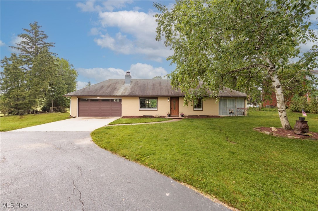 Wind down your paved driveway and into your own secluded one and a half acre lot! This one level living home on a serene parcel is calling you home. The exterior has been newly painted and your windows offer roll down shutters. The two car attached garage with newer garage door leave ample space for parking or your nice hobby space. There is additional space next to the garage to build or expand your garage. Once inside you are welcomed by your over sized living room with brick fireplace. There is also space to create a dinning area or expand into your three seasons room with the windows surrounding. Down the hallway is a kitchen remodel almost finished with allowing you to pick out your counters and backsplash. Newer appliances stay with the home as well. Down the hallway you have two large bedrooms and a full bath with warm and neutral updates. Inside the primary bedroom is a walk in closet with laundry for your convenience. The full basement is partially finished to offer additional living or entertaining space. Call today for your private showing before it's gone.