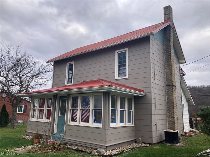 Updated home in historic Gnadenhutten - 3 BR - 1 1/2 BA plus new bathing room - recent updates include: 2nd level laundry - metal roof - newer windows - newer plumbing - new floor coverings - solid oak 6 panel doors - new cosmetics - fantastic country views - partially fenced back yard - walk in closets. Property is subject to new survey and back property line will be approx. 4' behind chain link fence. Remainder of land and garage negotiable for additional $20,000. Take a look and make this your home. Immediate Possession