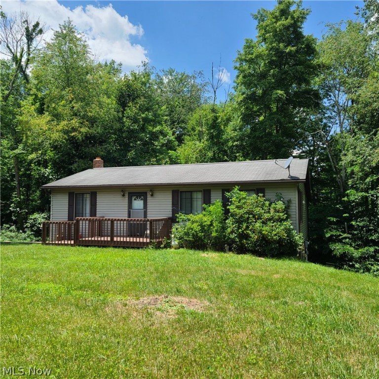 14.13 acres of beautiful land with a cute and cozy 2 bedroom, 960 sq foot home ready for it's new owner. In addition there is a 26x32 pole building with wood finishing the inside. There is plenty of land to add on or build your dream home. This home features a full basement, propane furnace, public water, septic, an unfinished sun room and deck overlooking the woods. The basement has a wood burning stove, laundry and a half bath. There are multiple outbuildings on the property.