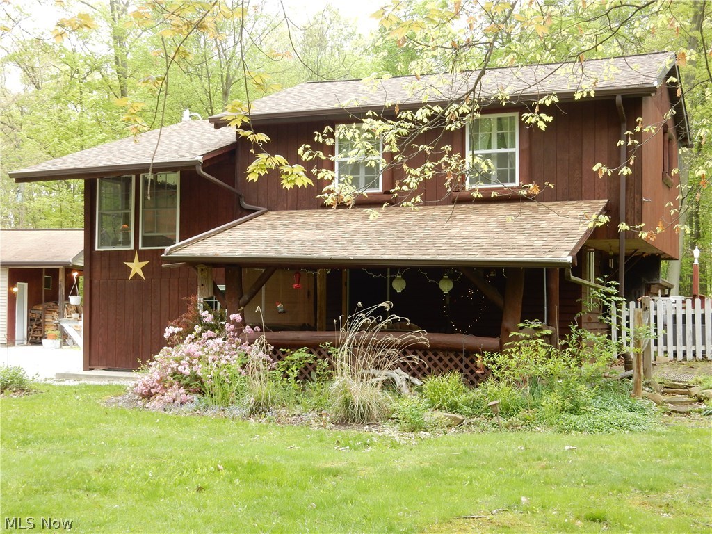 Quaint home nestled on 7+ acres within 1 mile of Berlin Lake. You will fall in love as soon as you turn onto the serene winding driveway that leads to the most unique home you may have ever seen. This home has many possibilities. Make it that great get-away, use it as a vacation rental or maybe you'd enjoy living here full time. The kitchen offers ample storage and hard surface counters and is open to the dining room. Both kitchen and dining room have beautiful ash hardwood floors. Down the winding stairs to the family room you will find a wood burning stove and log walls. The upstairs offers 2 sizable bedrooms and a full bath. Sitting in the enclosed front or back porches will make that morning cup of coffee taste even better. The walk out basement has all bathroom components yet they are not enclosed in a private bathroom setting. The stove, refrigerator, washer and dryer convey with the home. Outside, you will enjoy all the privacy you could ask for. Fish in your own pond, spend eve