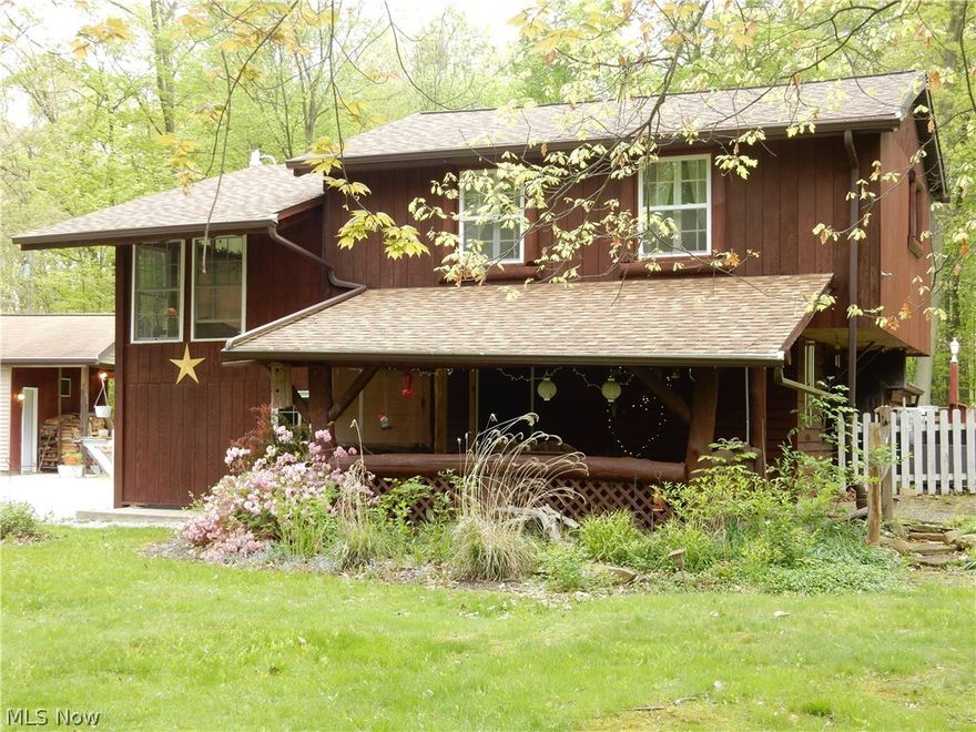 Quaint home nestled on 7+ acres within 1 mile of Berlin Lake. You will fall in love as soon as you turn onto the serene winding driveway that leads to the most unique home you may have ever seen. This home has many possibilities. Make it that great get-away, use it as a vacation rental or maybe you'd enjoy living here full time. The kitchen offers ample storage and hard surface counters and is open to the dining room. Both kitchen and dining room have beautiful ash hardwood floors. Down the winding stairs to the family room you will find a wood burning stove and log walls. The upstairs offers 2 sizable bedrooms and a full bath. Sitting in the enclosed front or back porches will make that morning cup of coffee taste even better. The walk out basement has all bathroom components yet they are not enclosed in a private bathroom setting. The stove, refrigerator, washer and dryer convey with the home. Outside, you will enjoy all the privacy you could ask for. Fish in your own pond, spend eve