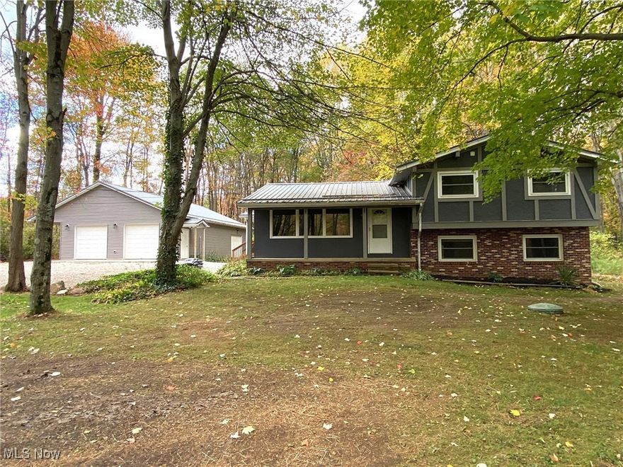 This Updated 4-Level Split sits on just over 8 Park-like Secluded Acres in Leroy Twp! Set back off the road, this warm and inviting home includes 3 Bedrooms, 2 Full Baths with neutral decor throughout. Covered front porch welcomes you into the vaulted Living Room & Dining Room combination with newer wood vinyl plank flooring. Eat-in Kitchen with breakfast bar & all appliances stay. Second floor includes Master Bedroom, 2 additional bedrooms with newer carpeting. Remodeled Full Bath with double sink vanity & quartz countertop. Lower level Family Room with pellet stove for additional heat source & slider to backyard to concrete patio & backyard, large Laundry Room & 2nd full bath. Basement includes finished Rec Room with glass block windows. Central air. HWT 2024. Wired for generator. Freshly painted exterior. Metal roof. This secluded property includes mature trees with large newer deck overlooking deep heavily wooded backyard & 30x40 Outbuilding/Garage with overhang, 3 overhead doors, plenty of room to park all your toys or ideal for the car collector or hobbyist. Ready for a new family to make this home their own! Just minutes to freeway access! Riverside Schools.