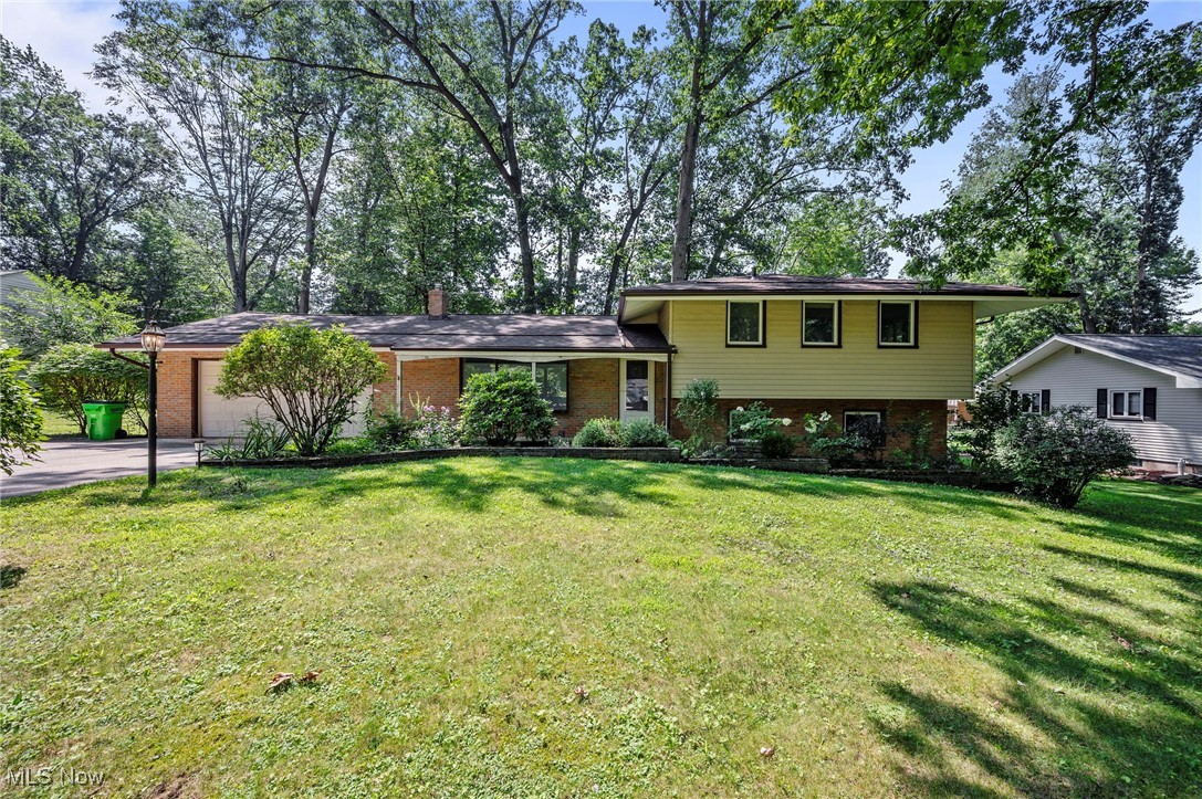 Tucked away on a quiet street, this versatile split-level home offers a thoughtful layout with room to spread out. The lower level features a living area, bedroom, and full bathroom. The main floor includes a second living area, an open dining space, and an eat-in kitchen with direct access to the rear patio and attached garage. Upstairs, you'll find the remaining bedrooms and another full bath. The home also includes a basement with generous storage or workspace potential. Hardwood floors run through much of the home, and the living room windows are fitted with removable frosted privacy clings. The spacious two-car garage provides ample room for storage or projects. Updates include a new sump pump, and radon mitigation system (2025), Owens-Corning Duration® roof (2023), Rheem 40-gallon hot water tank (2015), and a Weil-McLain boiler (2007). Schedule a showing today!