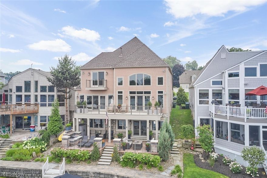 Million Dollar views in this stunning lakefront Portage Lakes home! Built in 2010 by KNL Custom Homes in the Heron Watch development, this home spares no detail inside or out and shows as brand new. The lake views were top of mind when this home was designed with the focal point being the two-story great room with floor to ceiling windows and stone fireplace as well as the impressive coffered ceiling and custom woodwork. The great room walks out to a large deck with amazing northern views of the East Reservoir. The open concept kitchen was remodeled  and features custom built cabinetry, ss appliances, double oven, large island and walk-in pantry. The first-floor master suite has incredible views of the lake, fireplace and the en-suite bath was remodeled with a new walk in shower, free standing tub, double vanity and large walk in closet. The third bedroom on the second level doubles as a home office with a custom built in desk and shelving. A third full en-suite bath and walk in closet