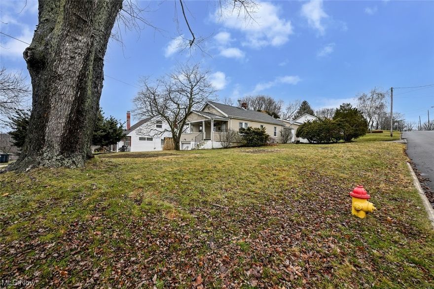 Garage, garage and 1 more garage! This 3 bedroom 1 bath with additional shower in basement raised ranch home welcomes you home with an oversized porch that invites you to a large family room with an abundance of windows for tons of natural light.  The living room opens seamlessly to the charming kitchen with tile floors and newer oak cabinets.  All bedrooms and bath are on the main floor. The basement has access to the 1 car attached garage and an oversized 2 car garage is steps away from the back door with easy access to the backyard.  Situated in the heart of Ellet located walking distance from school, this home is in an area of well maintained homes and is move-in ready. We are excited to show you this property- you are going to love it here!