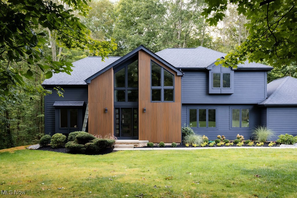 Nestled in a wooded setting,this fully renovated 4 bedroom,3.5 bath contemporary colonial combines privacy,modern updates,and timeless charm.A two-story foyer welcomes you with natural light while a French-door room offers flexibility as office or sitting area.The spacious great room with wood-burning fireplace and gas logs flows into a screened porch,perfect for morning coffee or evening relaxation.The formal dining room provides space for gatherings.The heart of the home is the newly redesigned kitchen with quartz counters,36” gas range and hood,refrigerator,built-in microwave,dishwasher,wine cooler,and 2 farmhouse sinks with disposals.A breakfast area complements the dining room while the new laundry room features washer tower and sink. The upstairs primary suite showcases vaulted ceiling,private balcony,custom walk-in closet,and a spa bath with heated floors,walk-in shower,soaking tub,dual vanities,and smart toilet.Two additional bedrooms share fully updated baths with new plumbing and electrical.The finished lower level includes 4th bedroom,full bath,new carpet,and versatile recreation space plus ample storage. Extensive 2023–2025 renovations make this home turnkey:Hardie board siding,roof coating,new concrete/asphalt driveway,garage floor and openers,landscaping,front door,sliding doors,windows,engineered hardwood floors,new interior doors,trim,paint,plumbing,electrical,panel,humidifier,tankless water heater,Kinetico and ozone water systems,custom accent wall in master,custom closets,updated baths with smart toilets,new appliances,new washer tower,basement carpet,and septic cleaned/tested.Located on a private street with access to an HOA lake for boating and fishing,this property offers the perfect balance of comfort,style,and natural beauty—ready to move in and enjoy.