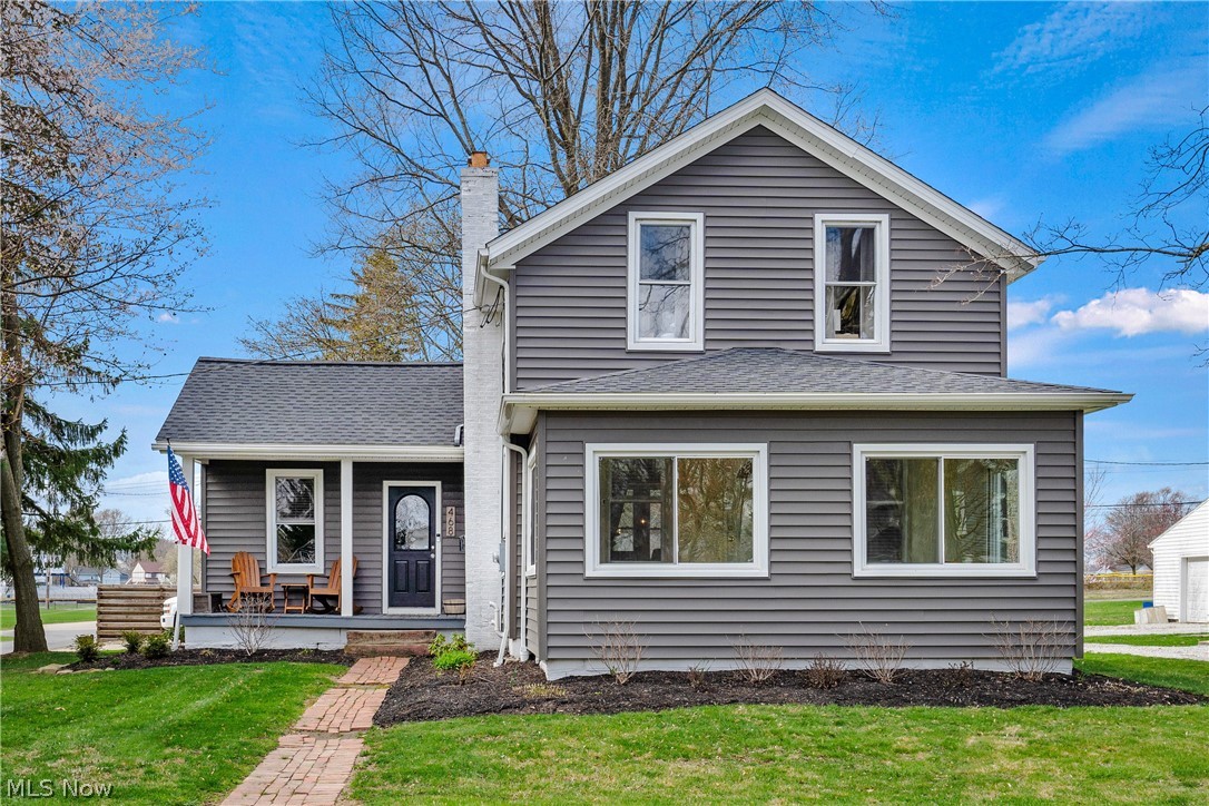 Beautifully updated & well maintained Colonial in IDEAL location. New waterproof vinyl flooring flows throughout the main level (2023). The chic, updated kitchen will not disappoint with stainless dishwasher, microwave & stove, plus island with butcher block countertop. The Living room is filled with natural light and boasts a beautiful floor to ceiling brick, woodburning fireplace. Dining area is open to living room & situated next to large windows with built-ins beneath. The full bath, located on the main level, provides warm, calm vibes with its many updates. The enclosed sunroom is impressive with cozy carpet, new sliding windows (2021) & ceiling fan. Spacious 1st floor laundry. Located on the second level, what was originally 3 bedrooms, has been opened up to 2 sizable bedrooms with carpet & nice closet/storage space. Super clean basement with lots of storage. The outdoors will wow you with a large back patio featuring a huge wet bar/kitchen with concrete countertops, storage, lighting & privacy. New Roof, siding, trim and gutters in 2021. Oversized garage has been updated with 100 amp service, 30 amp camper outlet, water, gas & concrete camper pad behind garage. Invisible electric fence. Parklike setting close to schools and the heart of downtown. This property has so much to offer! Don't miss your opportunity!
