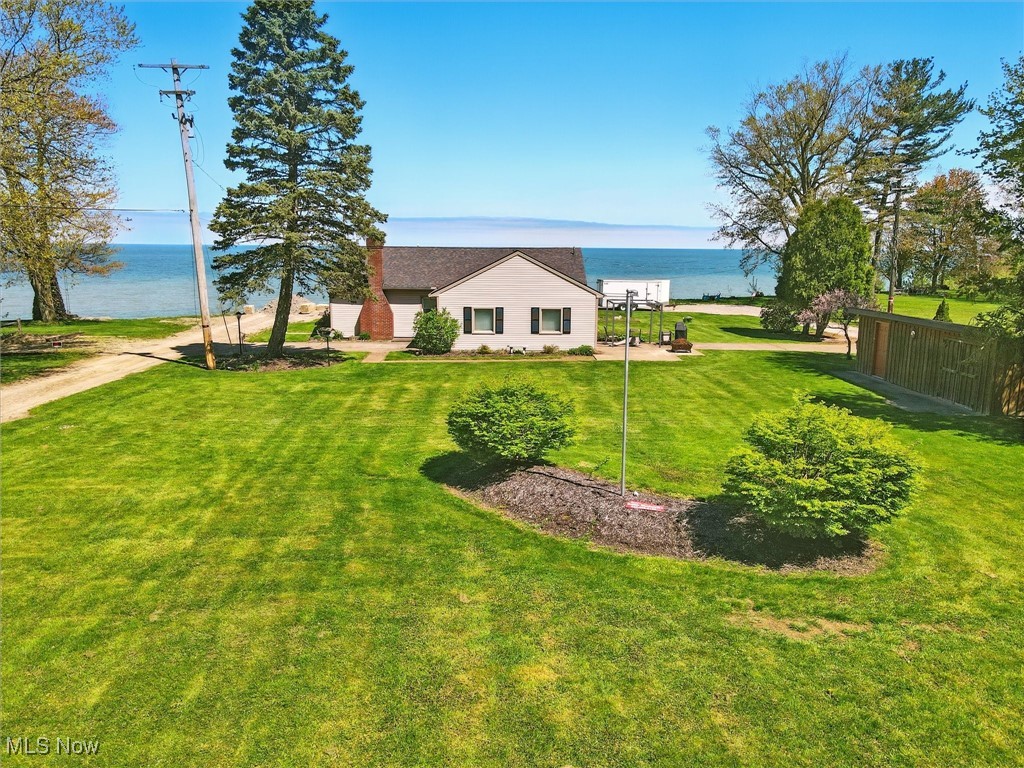 This delightful 2-bedroom, 1-bath ranch is your retreat close to the water. With vaulted family room ceilings, a peaceful patio, and stunning Lake Erie views, every detail invites relaxation. The property includes an outbuilding for added convenience. Whether you're looking for an income property or a serene escape, this home offers the perfect setting to unwind and recharge. Don’t miss your chance to experience near lakefront tranquility! The oversized eat-in kitchen has amazing counter space, loads of cabinets, a built in pantry. Currently operating as an Airbnb, it’s perfect as an income property, a weekend getaway, or your forever home. Don’t miss this rare opportunity to own a piece of paradise with close proximity to the lake!