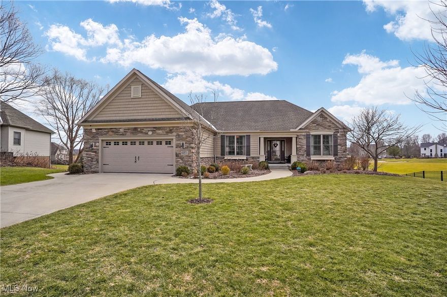 Welcome to this stunning custom built ranch home in the desired Pambi Farms neighborhood in Stow! This home offers spacious living with modern comforts. Featuring an open-concept design, the main level boasts a bright and airy family room with a cozy fireplace, and large windows providing plenty of natural light. Adjacent to the family room, is a nicely sized living room, or the space could be used as a formal dining room. The kitchen is a fantastic focal point to gather and host! It is complete with stainless steel appliances, quartz countertops, a center island, and ample cabinet space. You step out from the kitchen onto a wonderful composite deck with retracable awning over looking the pond and Roses Run Golf Course. The primary suite is a true retreat, featuring a walk-in closet and an en-suite bath with dual vanities, a soaking tub, and a separate shower. Completing the main floor are two sizable bedrooms with large closets, a full bathroom, and a nicely sized laundry room. Downstairs, the finished walk-out lower level offers even more living space! The lower level includes a large family room with a stone fireplace, kitchen with a quartz island, a fourth bedroom and full bath, perfect for guests, along with a workshop and plenty of additional storage. From the lower level, step outside to the covered patio to enjoy the beautiful backyard, perfect for entertaining or relaxing. This home is a must-see!