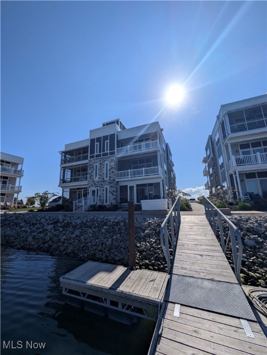 Happy Holidays! The temperature may be chilly BUT they won't be come springtime! Enjoy breathtaking, panoramic water views of the marina and Sandusky Bay from this like-new top-floor condo. Featuring two private balconies and a rooftop patio offering sunny exposures and unforgettable sunsets. This home is the perfect blend of luxury and relaxation. Optional sold-out 40' shoreline slip or furnishings available. Located in a premier waterfront development with a private beach, gazebo, heated in-ground pool, patios, and exclusive community events. Walk the sandy shoreline and experience the best of bayside living.