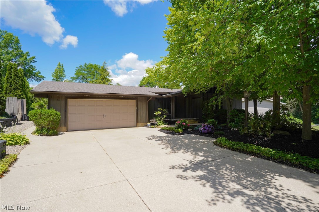 Mid-century flair ranch-style home, with distinctive wooden, vaulted and beamed ceilings bring a sense of spaciousness and architectural design and elegance. The front door is exquisite! Enter the home through the wooden, vaulted covered porch and into the open foyer also with a wooden ceiling, which is very unique! The spacious living room features a wooden, vaulted, beamed ceiling and lots of windows allowing for an abundance of light - there's even space for a dining area. The family room has a wood burning fireplace with a gas starter and also presents the amazing beamed ceilings. The primary bedroom offers double closets and convenient full bath. Two additional bedrooms are good sized with ample closet space. There is a convenient full bath with double sinks and a powder room equaling 2-1/2 baths. The eat in kitchen offers plenty of cabinet and counter space with all appliances included in the sale. The unfinished 12-course basement can easily be finished and would be a nice additional living or a recreation space - it's large enough to create an office, hobby area, and exercise room - whatever fits your needs. The garage is an oversized 2 car allowing for plenty of storage. One of the standout features of this home is the amazing, private and beautifully landscaped backyard and covered patio (again wooden vaulted ceiling) to enjoy the seasons. The shed even has electricity and a skylight! Updates include: Roof and garage door opener - 2019; Hot water tank - 2017; Furnace and AC - 2005. Home warranty is being provided by the sellers. This original owner designed the home and it has been meticulously maintained. Don't wait on this one! Property appraised significantly higher than the list price.