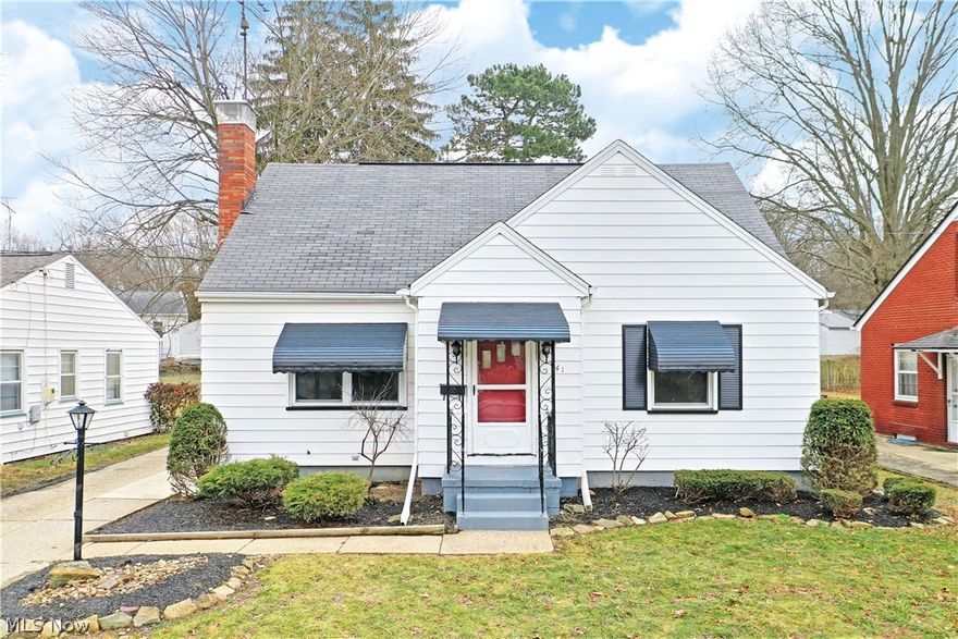 Casual and cozy, this move-in-ready Niles cape cod brings clean aesthetics inside and out with its inviting three-bedroom layout! Set in an advantageous location close to local schools and shopping districts alike, this residence packs plenty of charm with its hardwood filled living spaces and cottage like appearance. Stylish blue accent work pairs with a bright red entry door and manicured landscaping to draw you near. Front and side entrances extend from the concrete driveway while an oversized two car garage is located next to the fire pit laden side yard and rear sunroom. Inside, an engaging living room showcases its brick fireplace and beautiful flooring as natural light spills in from the front and side windows. Sculpted archways lead into the bright and cabinet filled kitchen as its white appliances match the counters and backsplash for a tidy style. The finished sunroom is found just steps away, making for easy warm weather dining and relaxation. A pair of spacious bedrooms joi