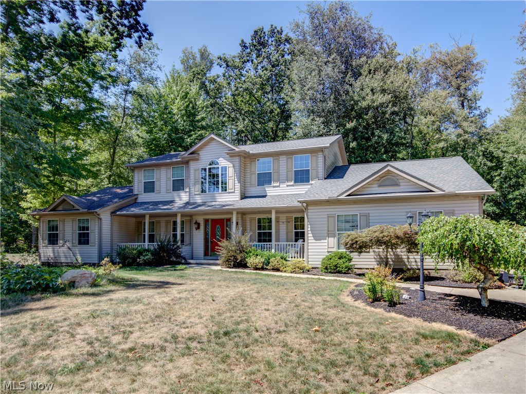 Spacious colonial built 2003 with 4 bedrooms, 3.5 baths, approx. 3500SF including finished lower level, on 1.05 acre cul de sac lot bordering Turkeyfoot Golf Course* So much to offer with 1st floor vaulted master & laundry, 9' ceilings, 2 story entry with wood floor, kitchen & eating area with wood floor, formal dining with tray ceiling & 3 car side load garage* Master bedroom with his & her walk in closet* Upper level with 3 bedrooms (1 has walk in closet) & guest bath with double vanity* Ceiling fans in most rooms* Finished lower level recreation room with bar, built in corner cabinet, office/exercise room & full bath* Glass block basement windows* Covered front porch* Deck overlooking park like private backyard* Security system* Updates include well, well pump (10/2016), pressure tank, softener & filter* Convenient location in Green & yet close to Portage Lakes*