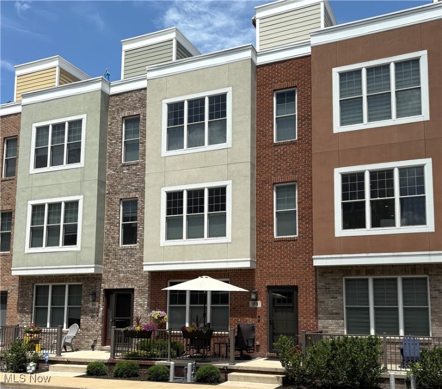 Welcome to this beautiful townhome in the desirable McKinley Place community. Ideally located in Lakewood’s west end it is only a 5- to 15-minute walk from the Rocky River Reservation, dozens of restaurants, coffee shops, retail boutiques, beauty shops and more. With 2 bedrooms, 2.5 baths, a 2-car attached garage, basement, and a private rooftop deck, this home offers a rare combination of luxury, flexibility, and location. The entry level features engineered hardwood flooring and a den/office accented by elegant wainscoting. On the second floor, enjoy a spacious, open-concept layout that includes a large living room, dining area, and kitchen with granite countertops, a center island with seating for six, a large pantry closet, and access to a balcony equipped with a gas line for grilling. The third floor features a generous primary suite with a custom walk-in closet and an en-suite bathroom that includes dual vanities and an oversized, tiled, walk-in shower. Down the hall is a guest bedroom, full bathroom, linen closet, and a laundry closet with a washer and dryer. Upstairs, a private rooftop deck offers the ultimate outdoor retreat. It is equipped with an electric SunSetter awning, gas line for a grill or fire pit, cable and electric outlets for a mounted TV, a water spigot and space for an indoor mini fridge. The 2-car garage includes a durable polyurea floor coating and two large overhead storage racks. The basement adds even more usable space with an additional storage platform. Additional features include upgraded lighting fixtures, retractable screen storm door, and a recirculating pump for quick hot water on the 3rd floor. McKinley Place is known for its strong sense of community, with residents gathering for events in the shared courtyard. This isn’t just a home—it’s a lifestyle. Whether you’re entertaining on the rooftop, working in the cozy office, or grabbing coffee down the block, you’ll love coming home to McKinley Place.