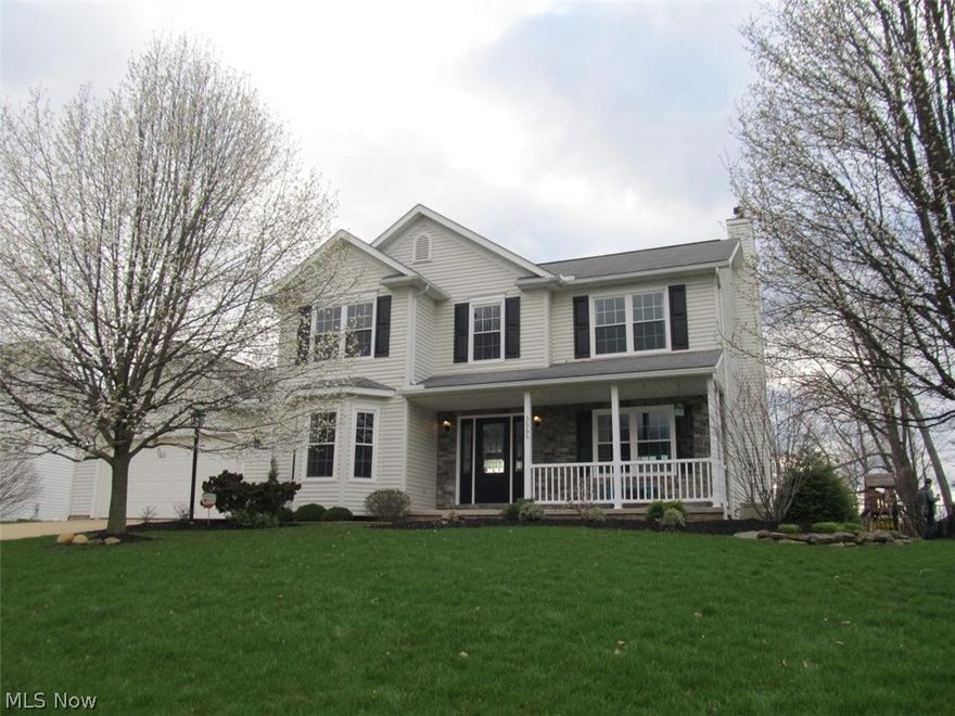 Beautifully updated 4 bedroom, 2.5 bath home in Green Local Schools! Updates include new windows, doors, and hardwood floors throughout with 6 inch white baseboards. Large eat-in kitchen has granite countertops, new backsplash, oversized ceramic tile floors, and large island. The great room has a gas fireplace with stone surround and white mantle. New sliding glass doors lead from the kitchen to a large, private, fenced backyard with stamped concrete patio (added in 2013) and swing set/club house. Professional landscaping includes two beautiful flowering pear trees in the front yard, and 15 Canadian hemlocks lining the side and back yards. The gorgeous front porch leads to a beautiful two story foyer with hardwood staircase. Upstairs you will find 4 updated bedrooms and two full baths. One of the four bedrooms has been converted into a dressing room with California Closets. Shelving can stay or go depending on buyers' preference. The finished basement includes wrought iron spindle stai