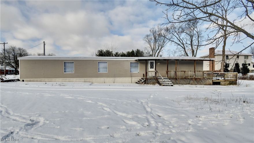 Ranch home! Welcome to this three-bedroom, two full bath home in Lake Township. Close to Lake Township Historical Society Museum. Come on up to the partially covered patio with wrap around deck where you can sit out and enjoy your morning coffee or entertain.  Open floor plan. New lights and new plumbing throughout. Spacious living room with ceiling fan, adjacent dining area, and kitchen. The kitchen features ample cabinetry, appliances, and a ceiling fan. Three bedrooms, two full bathrooms. Large garage space with storage area. Carport in front of the garage. Ready to move right in!