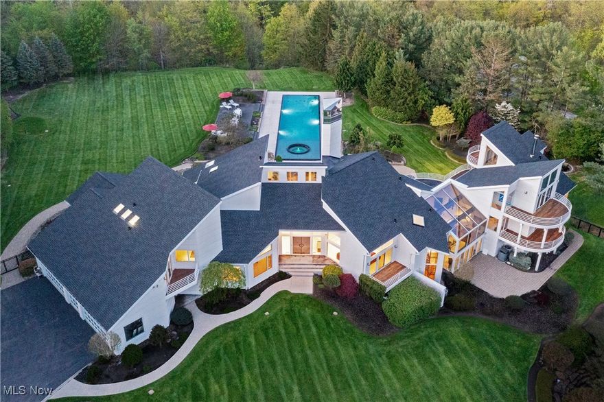 A Once-in-a-Lifetime Contemporary Masterpiece in Moreland Hills. Discover one of the most iconic and architecturally significant contemporary residences in Moreland Hills. Tucked away in a private, natural sanctuary, this one-of-a-kind estate offers a rare fusion of cutting-edge design, serene surroundings, and effortless elegance. The stunning backyard retreat is a work of art in itself—lushly landscaped and thoughtfully curated to provide the ultimate outdoor experience. From tranquil mornings surrounded by nature to vibrant evenings by the expansive pool under the stars, the setting is equally suited for intimate relaxation or unforgettable entertaining. Inside, expansive Richard Meier inspired open-concept living spaces are framed by soaring ceilings, clean architectural lines, and dramatic floor-to-ceiling windows that flood the interiors with natural light. Custom finishes, exceptional craftsmanship, and seamless indoor-outdoor flow define every detail. The dedicated entertainment wing is beyond compare—designed to host and impress at the highest level. Opportunities to own a residence of this caliber in Moreland Hills are exceedingly rare. This is more than just a home—it’s a bold statement, a lifestyle of distinction, and a singular opportunity to own a contemporary showpiece in one of Northeast Ohio’s most coveted enclaves.
