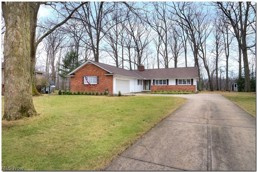 This is the perfect nature lover's home! Set on a 1.2 acre lot overlooking a picturesque ravine, you will enjoy summers in your lightly wooded back yard with soft moss under your feet. Three bedrooms and two full baths with a two car garage with additional parking spot in driveway. Kitchen with granite countertops, a serving window to the dining/family room, gorgeous hardwood floors in living room with recessed lighting, a dining room/family room, and a three season room on the side with almost 2,000 sq feet of living space!  New roof in 2018, new hot water tank in 2019.   Newer high efficiency furnace.