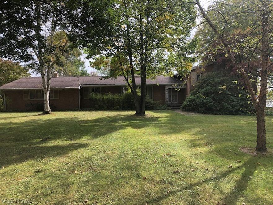 Breathtaking view of gorgeous lake. All brick Split Level home over 3,000 sq. ft., 2 fireplaces 3-4 bedrooms, 4 full baths, living room, kitchen, family room, rec room, dining room, both laundry and mud room. 2 car attached garage. 2 story small barn. Home needs updated. it's an estate home being sold AS IS. Great possibilities. 2 Acres in Marlington, make an offer! Call for details.