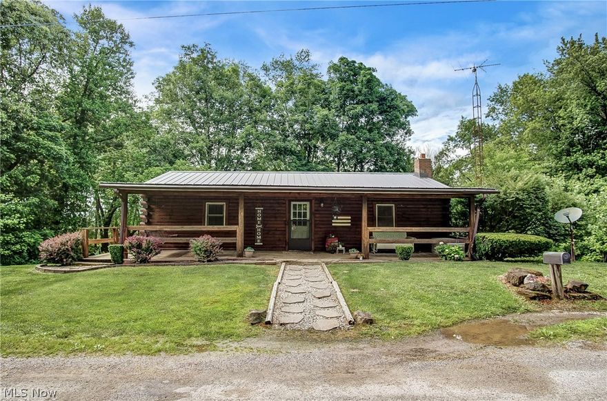This gorgeous log cabin home, located in the Tri-Valley LSD, is tucked away with 5.49 acres on 2 parcels. As you enter from the wrap around front porch, you'll love the open concept space with a large living room and plenty of cabinets in the kitchen too! The finished lower level area has 2 additional bedrooms, a full bath and a walkout door too! A new septic system and the new metal roof were both installed in 2021. A new well was installed in 2014. You'll love the metal pole building that could easily be a 2 car detached garage, workshop or additional storage space! It has a concrete floor, insulated paneling and its own electric too. The land has a park-like setting with trees, wildlife and a beautiful view of the creek. You can have bonfires, gatherings and even camp out in the beautiful, cleared, flat area! A property this size in Tri-Valley school district doesn't come around often! Call today!