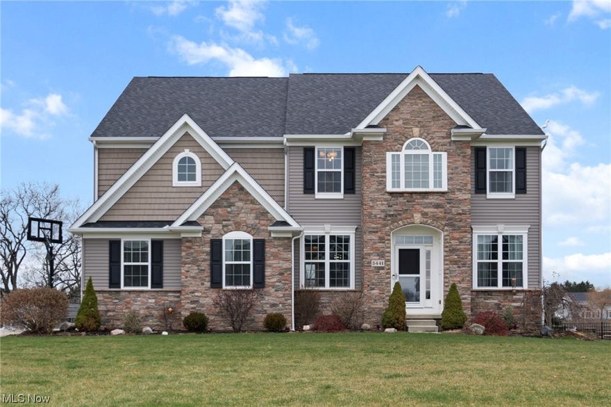 Stunning colonial in a highly desirable neighborhood in Valley City! Nestled on nearly a half acre and built in 2017, this home has had many updates inside and out since its construction. Boasting 5 large bedrooms and 3.5 bathrooms, there is no shortage of space with nearly 4,300 square feet of finished living area. Entering the home, you will be greeted by hand scraped hardwood flooring and an abundance of natural light. The gourmet kitchen features granite countertops, 42" cabinets, an island with seating and stainless steel appliances. The family room showcases the amazing views into the backyard. The first floor also has a formal dining area, a half bath and an office. Upstairs you will find a huge bonus room, 3 spare bedrooms, a spare bathroom and a huge master bedroom. Each of the spare bedrooms has its own walk-in closet! The master bathroom features double vanities with granite tops and a huge dual headed shower. A laundry room with its own utility tub completes the second floor. The full finished basement features a bedroom with an egress window (installed 2021), a full bathroom (bathroom expanded and shower added 2021), a huge recreation room, a bar and your very own wine cellar! Outdoor entertaining is a breeze with 2 large decks, a patio with a pergola and a hot tub! Inside or outside you can enjoy the wooded and lake view! A beautiful walking path circles the lake. Professional landscaping and lighting, a storage shed and a sprinkler system complete the exterior.  The 3 car garage is insulated and heated!