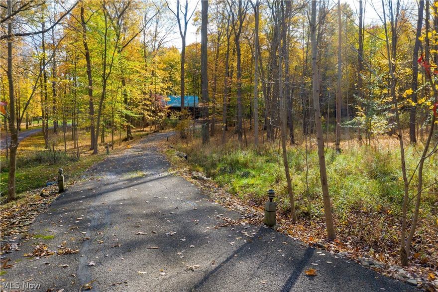 2924 Progress Park Dr, Stow, OH 44224 Is a GORGEOUS Log Cabin Home on almost 3 acres of beautiful land with serene views from all sides, stunning trees, wrap around drive set off the road for privacy! 2 car attached garage w/ plenty of storage, basement includes 3 main areas, workshop, Family Rm area & workshop, exercise & utility combo, large rear deck to ejoy the sun, trees & wildlife just steps away! Also, enjoy the covered front porch for shade or to listen to the rain on the trees to relax! Super cute workshed for yard toolds w/ covered firewood storage all in the heart of Stow yet on your own oasis! Walk in the front door to be immediately taken into your own dream home w/ absolutely gorgeous logs, your eye is drawn up to the loft from the wood stairs & handrail system & catheral ceiling, beautiful tones then to the woodburning fire stove for heat & beauty w/ stone surround rounding out the calming homestead feel! Enjoy the views of the long driveway & wilderness feel from your d