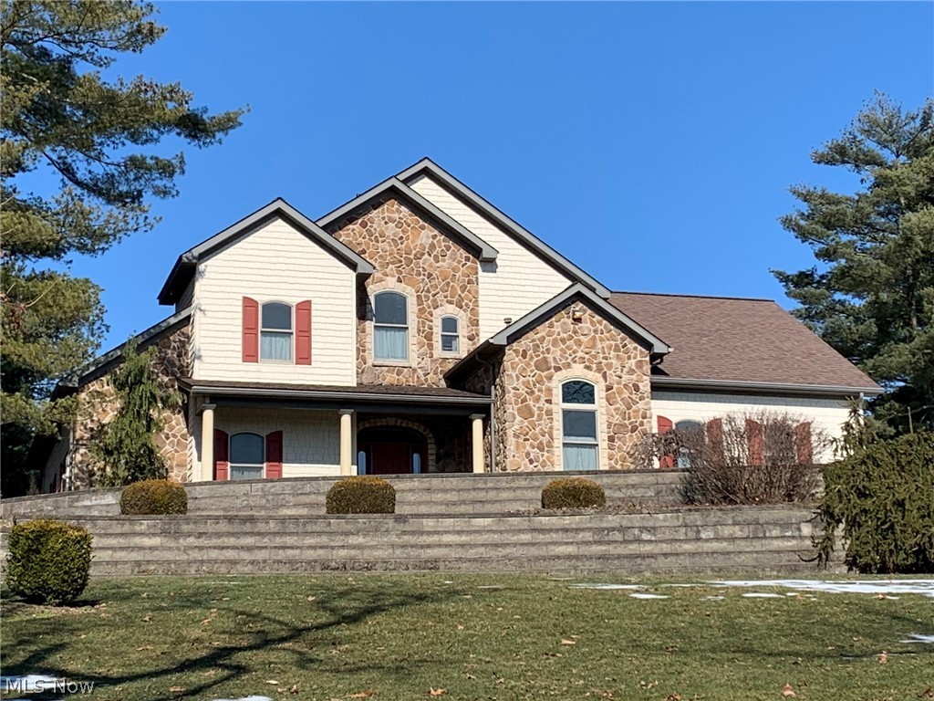 This awesome custom-built, 2 story home is situated on 4 picturesque acres and is complimented with a beautiful stone and Hardie board exterior. A gracious entry with guest closet opens to a fantastic great room with vaulted ceilings and gas burning fireplace. The open concept environment has ceiling-high custom windows with transoms, giving the back of the home an amazing wooded view. From there you flow into the dining area and gorgeous kitchen featuring custom cherry cabinetry, Corian counter tops, an island breakfast bar & all appliances. A combination mud/laundry room leads into the spacious 2 car heated garage. The deluxe 1st floor owners' suite is complete with a jetted soaking tub, large marble walk-in shower & roomy walk-in closet. The 2nd floor offers 2 generously sized bedrooms, a full bath & a wonderful huge loft with vaulted ceilings which would be ideal for an office or game/media room. Enjoy extra living space provided with a professionally finished lower level that incl