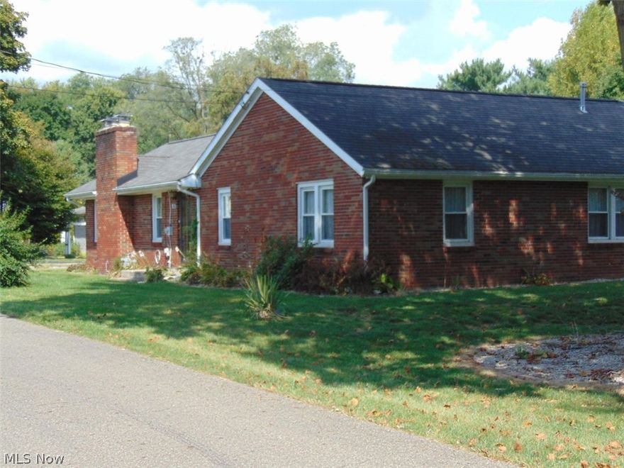 Nice brick 3 bdrm. home situated on a gorgeous lot.  3 car garage and outbuilding.