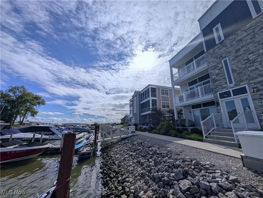 This one-of-a-kind waterfront condo includes two highly sought-after, sold-out amenities: a private shoreline 40' dock slip located directly in view below your balcony and a 40' storage garage! Perfect for your golf carts and summer watercraft. 

Inside your lake house the 3 bed/2 bath condo is filled with natural, welcoming sunlight thanks to your 2 private balconies. One is located waterside off of your living area space where you can see the natural landscaped marina and sunrays on the bay while the other is off of your master suite balcony w/ an additional custom window, with even more bay views and blue skies. Did we mention this building, #2 has a prime rooftop location 1st in line without any neighboring building interruptions? Better yet fully furnished with that lake life decor! Step outside and you're just one building away from the private beach and gazebo, grills, clubhouse, and sparkling pool ideal for relaxing weekends or entertaining guests. This is more than a condo it's a lifestyle of comfort, convenience, and waterfront luxury that's one-of-a-kind. Don't let this opportunity pass by!  A quick and easy move-in to enjoy the last few weeks of summer on the lake.