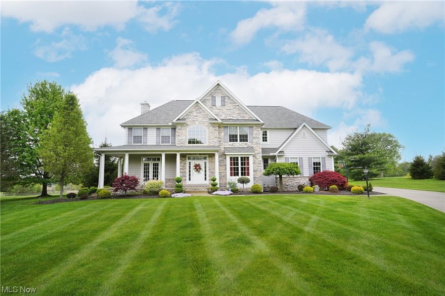 Stunning stone and vinyl colonial nestled on 2.78 acres in Granger Twp presents a fabulous open floor plan & spacious living areas.  Welcoming covered front porch captures moments of pure tranquility.  The two story foyer offers hardwood floors that flow through to the liv/din areas, staircase, & kitchen.  Inviting living rm boasts 2 sets of French doors, one set leading to porch.  Step down to the engaging great rm featuring stone gas fireplace, transomed windows w/plantation shutters, & stacked crown molding.  Sun filled chef's kitchen boasts center island/br bar w/distinctive pendant lighting, SS appliances incl double ovens & gas cooktop, palladian window, 3 skylights, and separate eating area w/outdoor access & overlooking great room.  Exquisite formal din rm w/ tray ceiling, wainscoting, & sconce lighting.  FF office (possible 5th bedroom) w/walls of built-ins & access to full bath.  Laundry rm w/cabinetry  conveniently located.  Elegant owners suite highlights h/h WIC & glamour