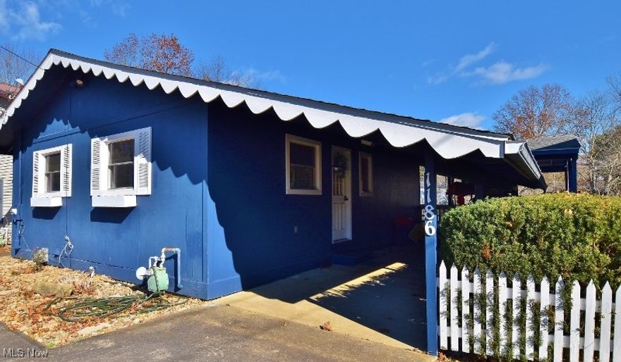 Charming partial waterfront home on private (non-lease) land at scenic Atwood Lake. Designed for low-maintenance living, this is the perfect weekend getaway—more time for fun and less time on yardwork. This 3-bedroom, 2-bath home sits on a quiet inlet on the stunning 1,540-acre lake, with your own dock slip on the Paradise Point dock only steps away, ready for your pontoon boat or other water toys. The home is cute as a button and ideal for family enjoyment and entertaining. The main level features a vaulted ceiling living room with skylights, open to an eat-in kitchen. A gorgeous wall of windows leads to the expansive covered deck with peaceful lake views. The kitchen includes all appliances, and most furnishings stay—making this a turnkey opportunity that saves you thousands. Two bedrooms with full closets and an updated full bath complete the main floor. The walkout lower level offers an additional 1,312 sq ft of living space, including a spacious family room and a recreation room that opens to a large stamped concrete patio and raised composite deck—an incredible outdoor living setup. This level also includes a third bedroom, a combination laundry/second full bath, and a generous mechanical/storage room. There’s plenty of space for family and friends to make memories for years to come. Additional features include new windows and luxury vinyl plank flooring throughout. Concrete driveway with ample parking for at least four cars including a one-car carport. Residents can also enjoy the relaxing community beach. Isn’t it time to make your lake-home dream a reality? Don’t miss the 3D virtual tour for an up-close look at this inviting retreat. Perfect opportunity for your second home or certainly ready for year round living. Call to schedule a personal showing today.