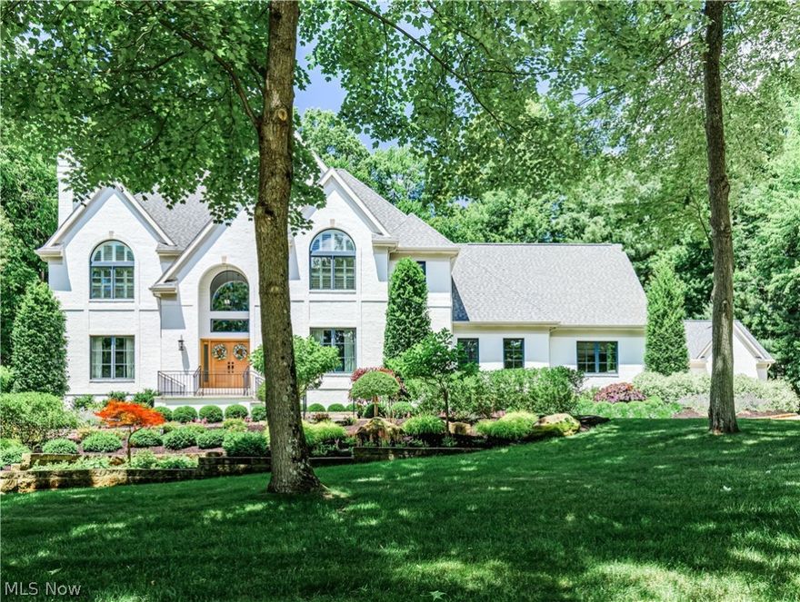 COMPLETELY UPDATED with CARRIAGE HOUSE in Crystal Shores, this property has been meticulously upgraded throughout, setting a new standard of luxury. Renowned for their craftsmanship, DR Miller Design Build has transformed this 6BR, 6.2BA estate on 1.6 acres into an extraordinary residence.  Step into an elegant foyer that leads to a living room with a roaring fireplace, a sumptuous dining room, and a grand great room featuring another fireplace, a wet bar, and seamless access to expansive outdoor living spaces. The brand-new kitchen boasts a central island, casual dining area with a bay window, walk in pantry and opens onto a patio with an outdoor kitchen, perfect for al fresco dining.  Private paneled office also on main level.   A well-appointed mudroom with a laundry area, cubbies, and half bath ensures functionality.  Upstairs, discover 4 spacious bedrooms, each with its own en-suite bath, complemented by a stunning primary suite. This sanctuary features a fireplace, 2 walk-in closets, and a spa-like bath complete with a soaking tub and oversized shower.  The lower level is an entertainer's dream with a rec room, bar, wine storage wall, and access to a private hot tub and patio area. Additional highlights are a 5th bedroom, workout room, and a versatile play area.  Outside, enjoy beautifully landscaped grounds featuring a fire table sitting area, outdoor kitchen, dining, kitchen and path leading to Carriage House. This charming structure offers covered seating with TV, fireplace, heaters and inside a Golf Simulator with a kitchenette and 4th garage bay. Upstairs is the 6th bedroom with the 6th full bath.  Surrounded by wooded views for ultimate privacy, this property offers the convenience of Bath Township living with city water and sewer services. Updates from 2019 to 2023 ensure modern comfort (see full list of updates).  Don't miss the opportunity to experience this exceptional property just minutes from every amenity. Call today to arrange your private tour.