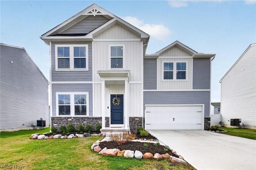 A rare opportunity to enjoy the benefits of new construction without the timeline! Move right in to this 2024 colonial by K. Hovnanian in the Harvest Meadows community in Elyria. Located in the Midview School District, this home offers the brand-new feeling with the added benefit of completed finishes, a fully fenced backyard and blinds already in place. This 4-bedroom, 2.5-bath home features a bright, open-concept layout designed for everyday living and easy entertaining. The family room flows seamlessly into the dining area and eat-in kitchen, where granite countertops, a center island with breakfast bar, stainless steel appliances, and ample cabinetry create a functional and inviting space. The kitchen leads directly to the covered deck, extending living outdoors and overlooking the spacious, fully fenced yard. The primary suite offers a comfortable retreat with a walk-in closet and private en-suite bath featuring a double vanity and tiled walk-in shower. Three additional bedrooms, a full bath, and a convenient 2nd-floor laundry room complete the upper level. A full basement with rough-in plumbing for a full bath provides excellent potential for future living space and an attached 2-car garage offers added convenience and storage. RECENT UPDATES COMPLETED AFTER BUILDING: Installed wood fence & gate (2025), custom blinds throughout (2024), professionally completed drywall finishing in garage (2024), professionally installed rock landscaping in front of house (2025), installed screen door on door to back deck (2025), ceiling fan in master bedroom (2025), hanging racks in garage, painting throughout most of the house (2025/2026), and more. INCLUDED are ALL kitchen appliances, washer/dryer, and window treatments. Conveniently located near US-20, OH-10/OH-57, shopping, restaurants, schools, Cascade Park, Carlisle Reservation, golf courses, and other local attractions. This home is a must see!