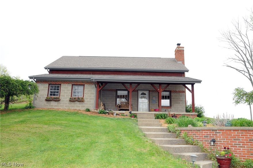 Enjoy the quiet country surroundings in this beautiful custom built block/brick home in East Muskingum School District.  Three bedroom, two bath home with open floor plan.  Cozy family room with stone base woodburner to save on heating.  Large loft area offers multiple possibilities.  County water with extra tap to garage, new septic installed 2005.  Detached garage with over 2448 square feet of space, three bay doors, 1 - 16', 2 - 8'.