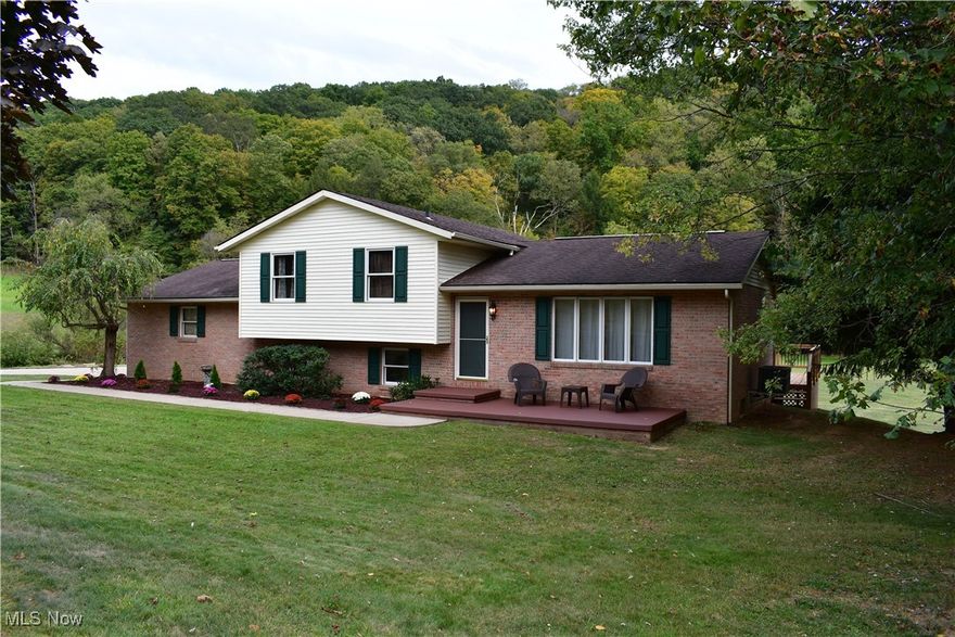 Discover the perfect blend of nature, privacy, and modern living in this beautiful home sitting on over 6 acres. Bordering Tomlinson Run State Park and just minutes from both Pennsylvania and Ohio, this location offers unmatched convenience and a peaceful retreat with stunning natural surroundings.
The property boasts an abundance of wildlife, lush landscaping, and a creek running along the edge, creating the ideal setting for outdoor lovers. Step inside to an open living room with rich hardwood floors and soaring ceilings that exude warmth and charm. The hardwood flooring continues through the updated kitchen and dining area, where sliding glass doors open to a spacious deck overlooking the picturesque backyard and creek.
Upstairs, you’ll find three comfortable bedrooms, each featuring new carpet and baseboards. The primary bedroom includes an ensuite bath, and the newly renovated main bathroom offers double sinks, modern finishes, and chic storage mirrors.
The lower level is designed for comfort and functionality, featuring a cozy family room with a fireplace, a versatile bonus room, and an updated laundry room equipped with extra cabinets and shelving for added storage.
The oversized garage comes with a built-in workbench, and the paved driveway provides plenty of parking for guests. The entire interior has been freshly painted, ready for you to move in and make it your own.
Surrounded by nature with every modern convenience at your fingertips, this home is a rare find. Schedule your showing today and experience the beauty and comfort this exceptional property has to offer!