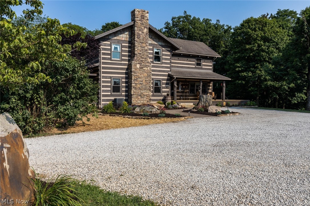 A rare and unique find. This full 2 story Hearthstone Log Home is constructed of large hand-hewn timbers. Located on a quiet 8 acres of beautiful country and within 1 hour of downtown Columbus. Enjoy an abundance of wildlife from the 2 covered timber porches with full cedar tree post or the open deck out back with amazing country views surrounding this home.
This home has so much to offer with first floor oak flooring and kitchen cabinets. The open living room has a 25’ cathedral ceiling supported by a full cedar tree trunk. The large woodburning fireplace was designed from stones salvaged from the original homestead on the property. The bonus area off the living room could be a 1st floor office or bedroom. The kitchen and dining are 9’ timber ceilings with a large triple window and garden door to deck. All ceilings in the home are timbers with 2x6 tongue and groove decking.
The heavy timber stair case takes you upstairs where you come into an open loft that overlooks th