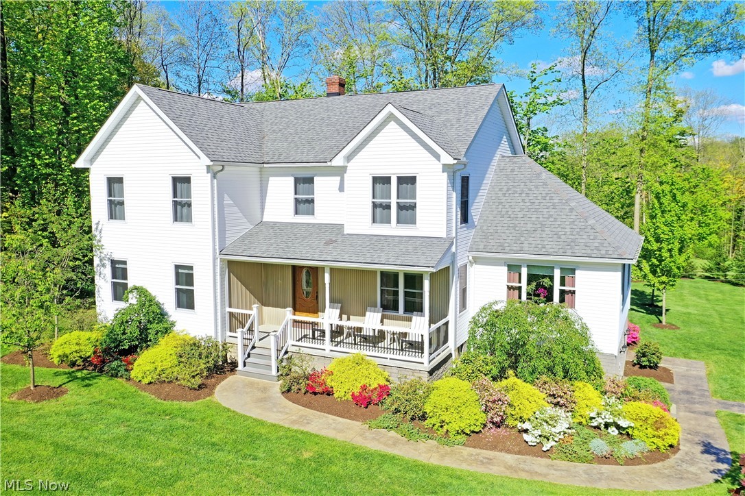 The sky is the limit with this expansive three-structure horse property in Chardon. Masterful landscaping lines the road as a winding driveway circle a center island for easy in and out access. A two-story home brings three floors of living space as a massive outbuilding and stable sit nearby with attractive steel roofing and clean, modern appearances. The residence itself quickly stands out with its sloping rooflines, covered front porch, and a rear patio that overlooks a formed cement walkway and firepit. A walk-out basement offers easy access while the main entry leads into an inviting living room. A robust kitchen brings multiple walk-in pantries as dining overlooks the patio space. The first-floor master bedroom suite entails a tiled shower with a walk-in closet. A second half bath and guest room complete the level. Upstairs, a trio of illustrious bedrooms explodes with natural light and large footprints. A full bath awaits mid-hall with a fourth bonus room. An additional bedroom