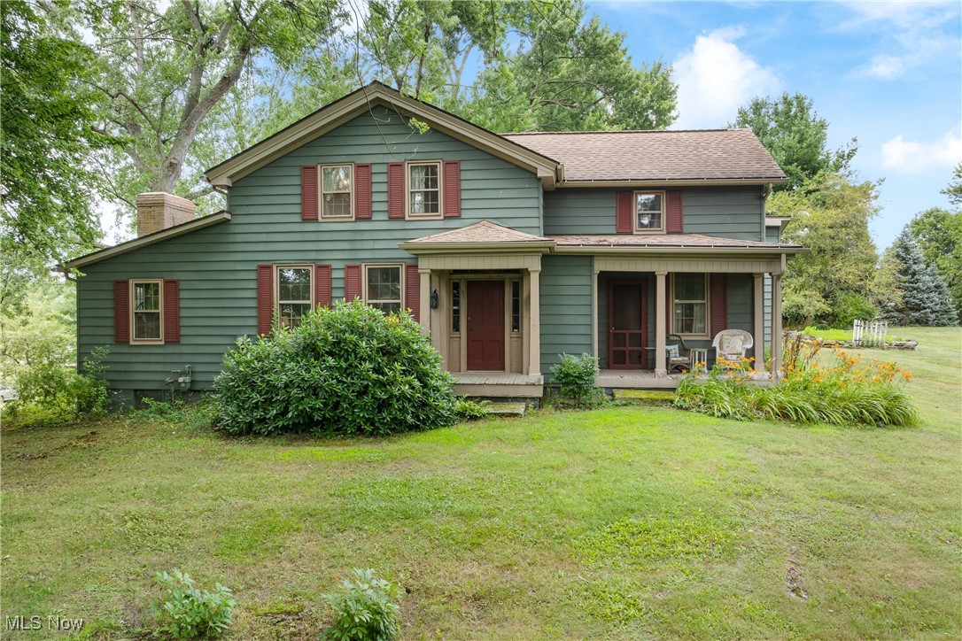 Step back in time with this beautifully preserved century home—the original residence of the Williamsburg neighborhood in desirable Lake Township. Brimming with character, this 4 bedroom and 2 bath treasure, sitting on a one acre lot, features original hardwood floors and rustic, primitive décor that celebrates its timeless heritage. The inviting screened-in porch, complete with a classic porch swing, overlooks colorful and serene landscaped gardens within a fenced, private backyard—an ideal retreat for peaceful mornings and quiet evenings. Inside, you'll find spacious living throughout, including a first floor master with a soaring vaulted ceiling. A grand, oversized wood-burning fireplace anchors the large family room, perfect for cozy gatherings. Additional living spaces include a formal living room and a bright, welcoming dining room—each space telling its own story. The laundry can be conveniently found on the first floor next to the eat-in kitchen with breakfast bar. Upstairs, there are 3 spacious and comfortable bedrooms. They certainly don’t build them like this anymore. With a strong foundation and craftsmanship that has stood the test of time since the 1840's, this special and well-loved home is a rare blend of history, charm, and functionality—waiting for its next chapter. Make sure to schedule your showing today. This incredible piece of history will not last long!